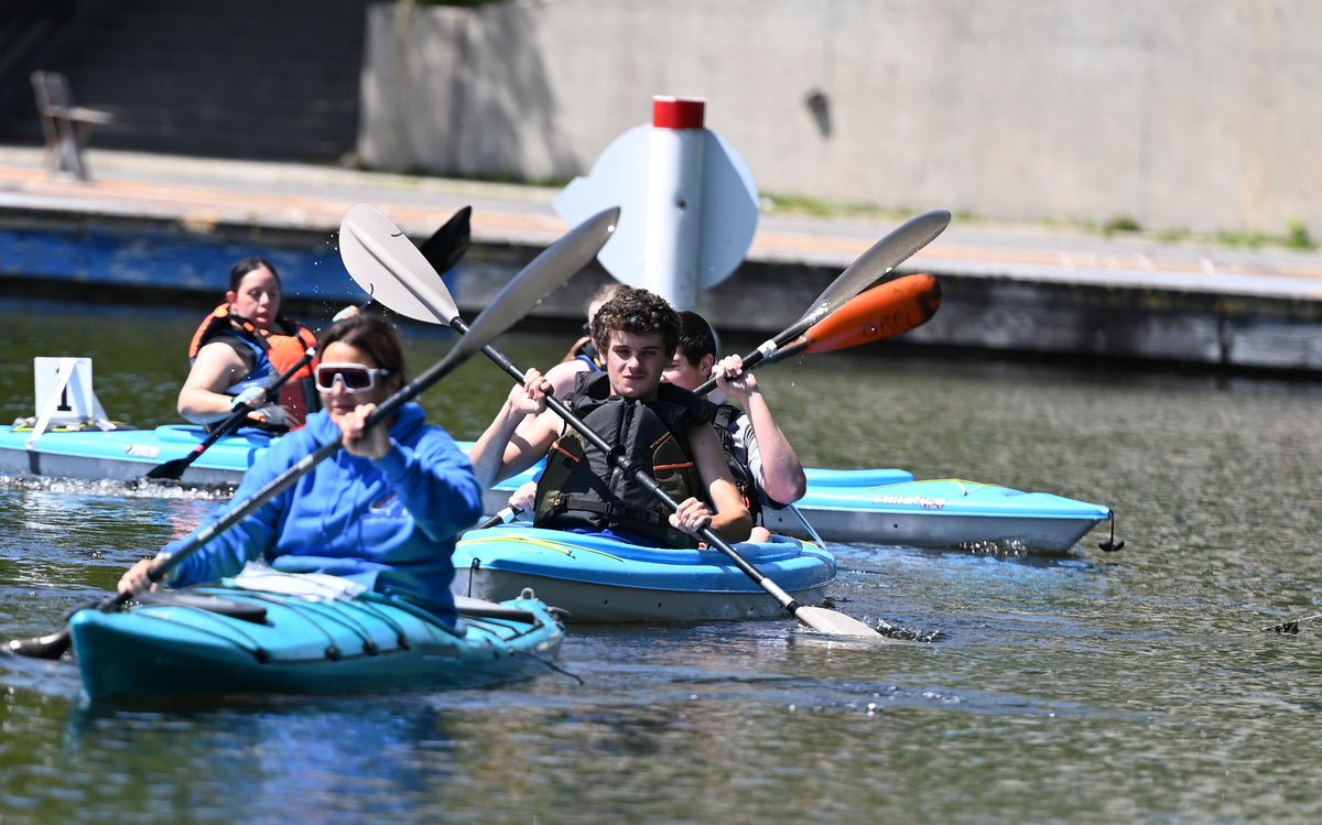 ORCC SO athletes paddle to the start line following Coach Andrea.