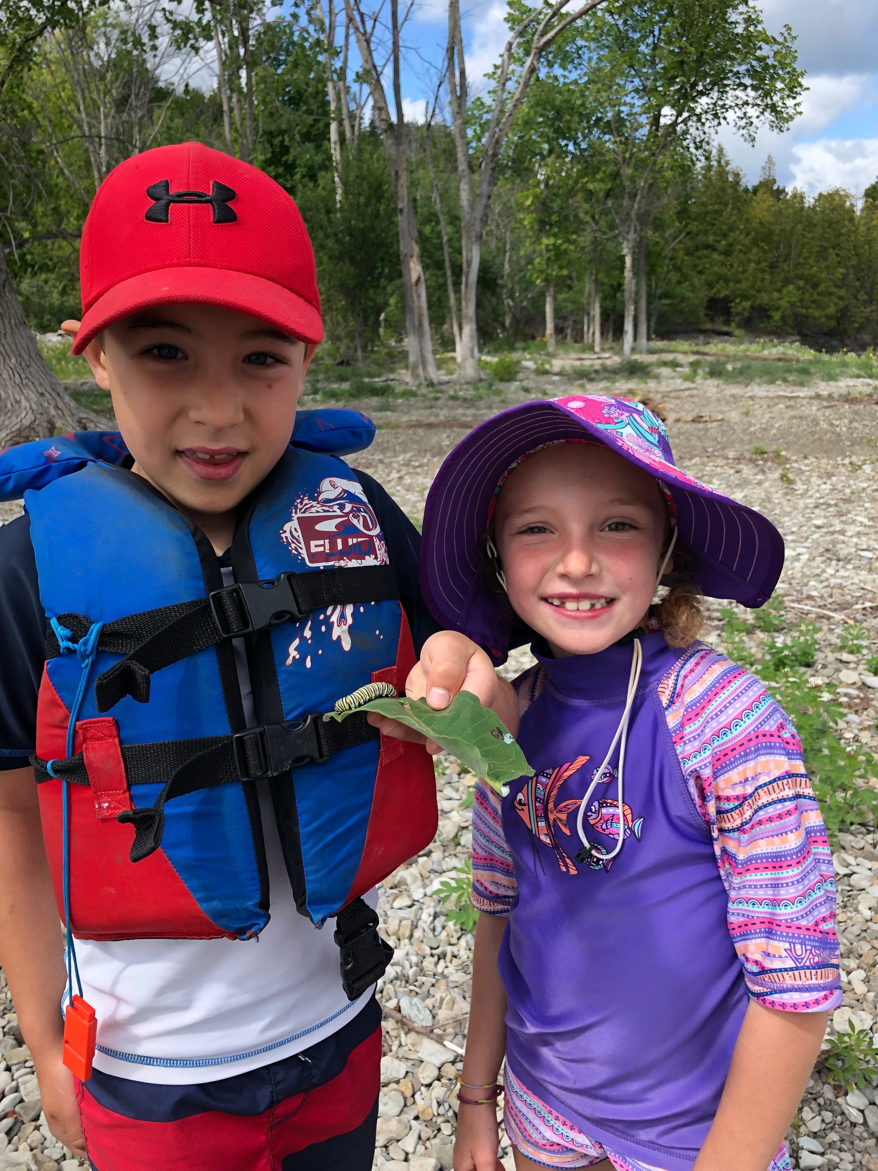Junior Canoe Kids campers finding a catepillar at the beach while exploring!