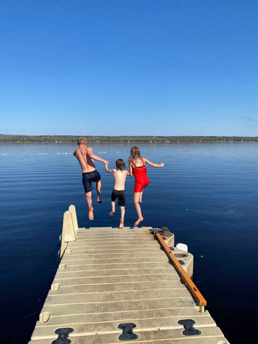 Longtime club members go for a swim on a beautiful autumn evening off the end of our dock.